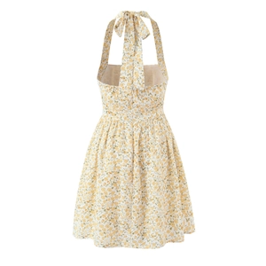 Robe d'été jaune à fleurs avec dos nu et grand nœud papillon noué autour du cou