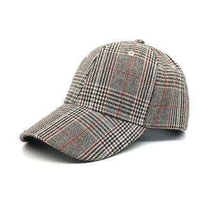 Close-up of retro houndstooth pattern baseball cap with red accents and fine stitching