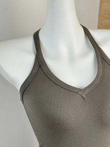 Close-up of ribbed texture and deep V-neckline on brown elastic camisole top