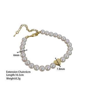 Detail of 6mm freshwater pearl bracelet with a gold heart pendant and lobster clasp