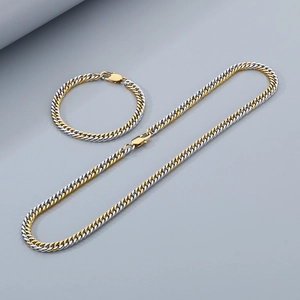 Détail d'un ensemble collier et bracelet à mailles gourmette bicolores or et argent