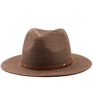 Detailed close-up of dark brown woven straw Panama hat with a leather band and gold stud