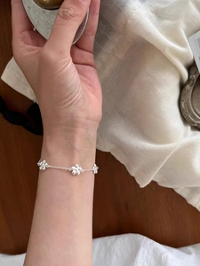 Close-up of elegant s925 silver flower bracelet worn on wrist for aesthetic detail