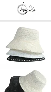 Detailed view of floral lace sun hat with elegant pearl trim and breathable mesh fabric