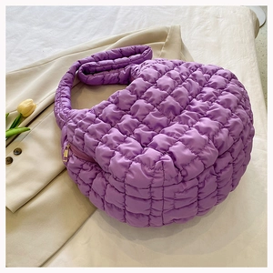 Detailed view of purple quilted cloud bag texture and pleated bubble fabric design
