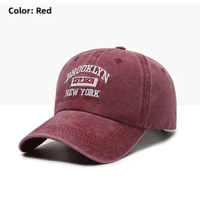 Detailed close-up of vintage washed burgundy baseball cap with white Brooklyn embroidery