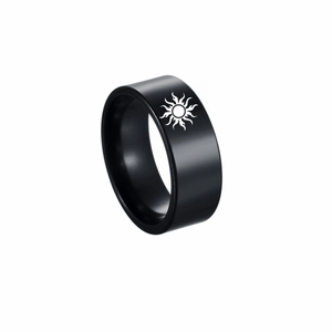 Close-up of 8mm black stainless steel ring with white laser-etched sun totem symbol