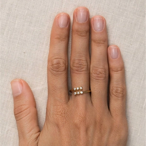 Close-up of a gold-plated S925 silver leaf ring with crystals on a linen background