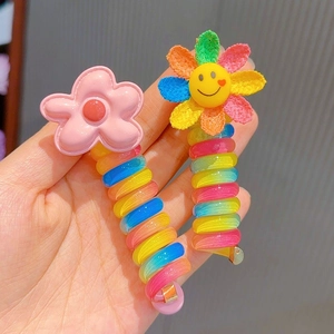 Detail of colorful spiral telephone cord hair clips with cute flower and sunflower charms