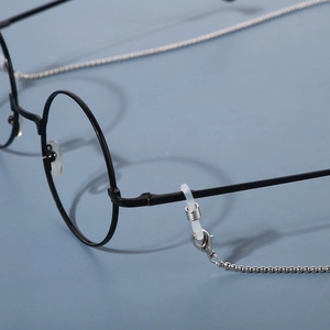 Detail view of silver metal eyewear chain with lobster clasp and silicone loop attachment