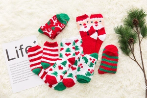 Cozy Christmas coral fleece socks with reindeer and Santa patterns on plush background