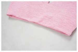 Close-up of pink brushed knit yoga bra fabric showing fine texture and neat stitching