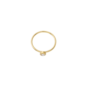 Macro detail of minimalist gold ring featuring a bezel-set round sparkling birthstone