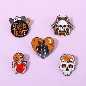Detailed set of five Halloween enamel pins featuring pumpkin, skull, and spider web motifs