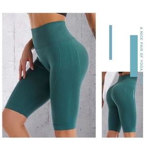 Detailed close-up of seamless teal high-waist yoga shorts with supportive fabric texture