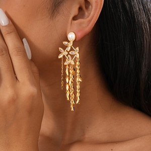 Detail of 18K gold-plated long tassel earrings with pearls and crystal flowers