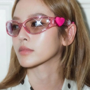 Y2K pink heart sunglasses with transparent frame and star detail on model
