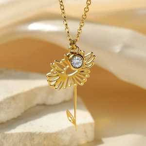 Detail of sunflower pendant with hollow petals and zircon on 18k gold plated necklace