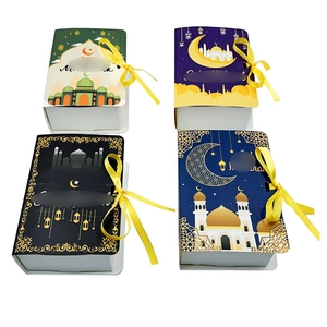Detail of Eid Mubarak book-shaped gift boxes with mosque patterns and yellow ribbons