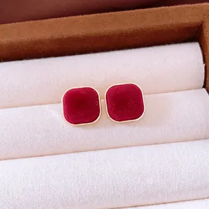 Vintage red flocked square earrings with gold metal frame in a luxury jewelry box