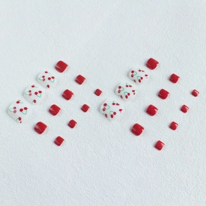 24pcs press-on toe nails with cherry patterns and solid red finish on white background