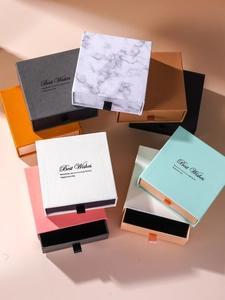 Detail of multi-colored drawer style jewelry gift boxes with Best Wishes gold foil printing