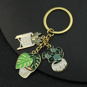 Detail of succulent keychain with Monstera leaf and crazy plant lady enamel charms