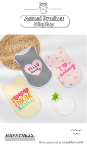 Three assorted cute pet vests with floral and striped patterns on a decorative woven mat