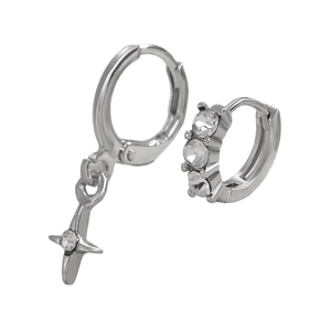 Detail of silver asymmetric earrings featuring a star pendant and cubic zirconia hoops