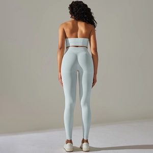 Detail showing back view of light blue ribbed seamless halter sports top and yoga leggings