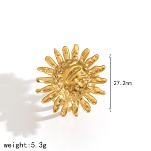 Detailed macro of a 18k gold sunburst flower ring with hammered texture metal finish