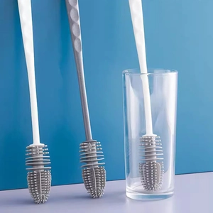 Detailed view of long handle silicone cup brushes in a clear glass for deep cleaning