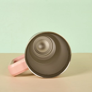Detail view showing polished 304 stainless steel interior and pink handle of the tumbler