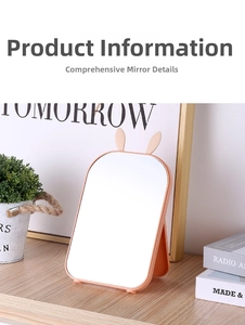 Pink rabbit-ear folding makeup mirror on a desk with adjustable stand for dorm use