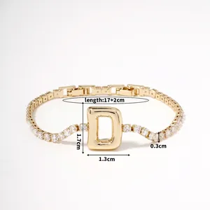 Macro shot of gold-plated chain bracelet with zircon stones and letter D charm dimensions