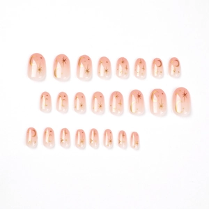 Pink gradient short round press-on nails featuring gold moon and star patterns