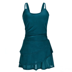 Detail of teal skirted swimsuit featuring ruched waist and layered ruffle hemline