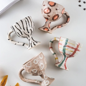 Handcrafted ceramic mugs set featuring leopard and zebra patterns on a white background