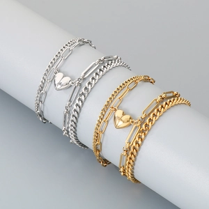 Macro view of layered stainless steel heart magnet bracelet in gold and silver finish