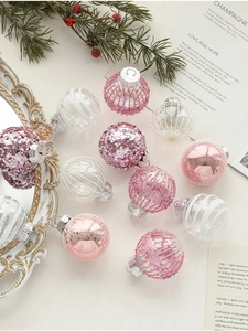 Close-up of pink and silver Christmas balls with glitter and striped textures