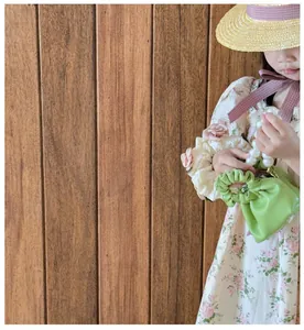 Detailed view of children pearl handle handbag with ruched pleats in avocado green