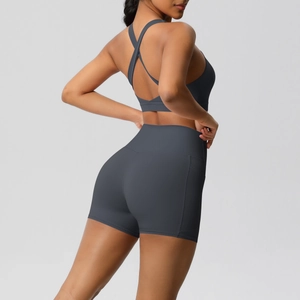 Detail of cross-back sports bra and high-waisted shorts with side pockets in grey