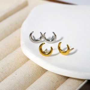 Minimalist crescent moon stud earrings in polished gold and silver stainless steel