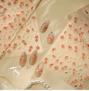 Detail of TL-449 nail stickers featuring red floral patterns and gold embossed lines