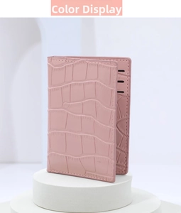 Detail of pink stone-embossed card holder showing precise stitching and card slots