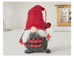 Detail of female Christmas gnome doll with red knitted hat and white plush braids