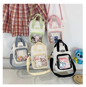 Ita Bag selection featuring transparent PVC display pocket and crossbody canvas design