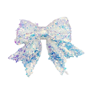 Iridescent white oversized Christmas bow with holographic sparkle for mall and cake decoration