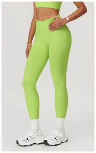 Full view of lime green high waisted yoga pants with elastic fabric texture on a model