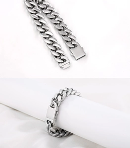 Macro detail of 13mm silver polished stainless steel Cuban chain bracelet with box clasp